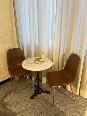 two chairs and a table in front of a window at Kolev Apartment in Sofia