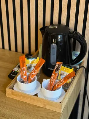 a tray with two cups of snacks and a tea kettle at Kolev Apartment in Sofia