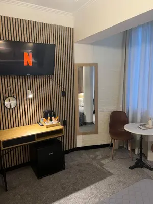 a room with a desk and a mirror and a table at Kolev Apartment in Sofia