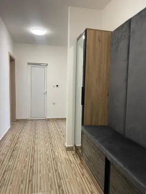an empty room with a couch and a door at Апартамент Кashmir in Smolyan