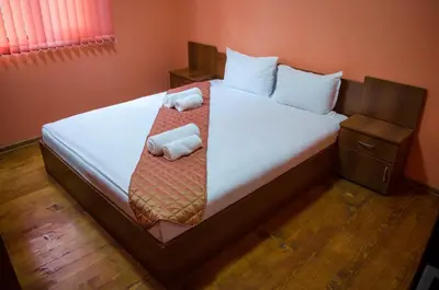 a bedroom with a bed with two towels on it at Yoneda Houses in Sapareva Banya