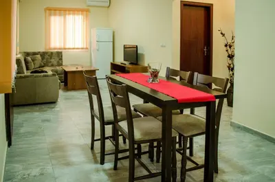 a dining room with a table with a red table cloth at Yoneda Houses in Sapareva Banya