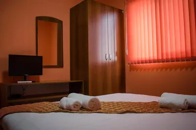 a hotel room with a bed with towels on it at Yoneda Houses in Sapareva Banya