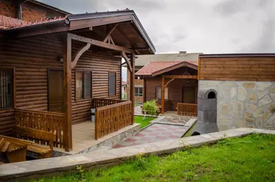 a wooden cabin with a porch and a patio at Yoneda Houses in Sapareva Banya