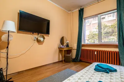 a bedroom with a flat screen tv on the wall at Charming Central Retreat! in Sofia