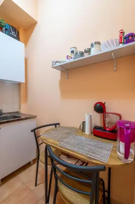 a kitchen with a table and chairs in a room at Charming Central Retreat! in Sofia