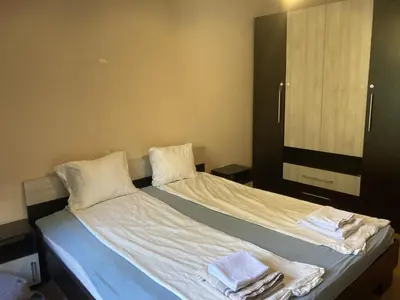 a bedroom with a bed with towels on it at Kyluks 1BR Apartment in Sofia