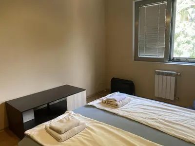 a bedroom with two beds with towels on them at Kyluks 1BR Apartment in Sofia