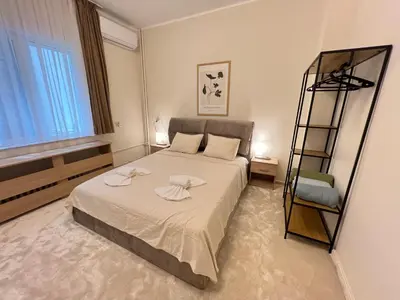 a bedroom with a bed with towels on it at Cozy 1BDR with Jacuzzi and WiFi near Vitosha BLVD in Sofia