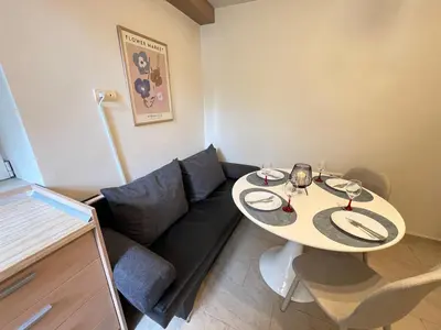 a small living room with a table and a couch at Cozy 1BDR with Jacuzzi and WiFi near Vitosha BLVD in Sofia