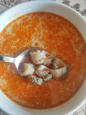 a bowl of soup with a spoon in it at Кулинарна къща за гости СОФРИЦА in Hvoyna