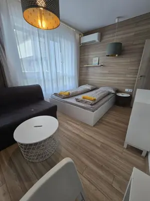 a living room with a bed and a couch at Happy Home in Sofia