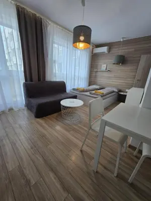 a living room with a couch and a table at Happy Home in Sofia