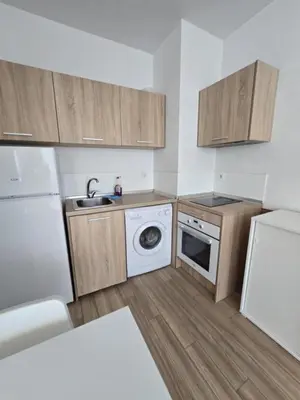 a kitchen with a washer and a sink and a refrigerator at Happy Home in Sofia