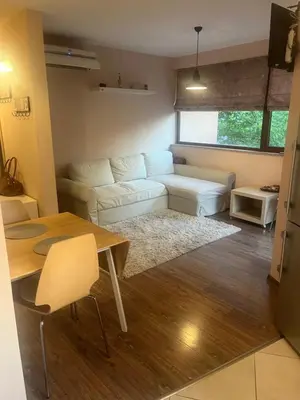 a living room with a white couch and a table at Guest House Amaya Happy in Plovdiv