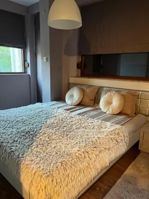 a bedroom with a bed with a furry blanket on it at Guest House Amaya Happy in Plovdiv