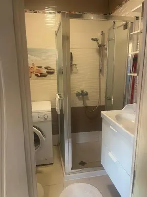 a bathroom with a shower and a washing machine at Guest House Amaya Happy in Plovdiv