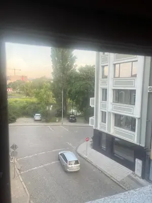 a car parked in a parking lot next to a building at Guest House Amaya Happy in Plovdiv
