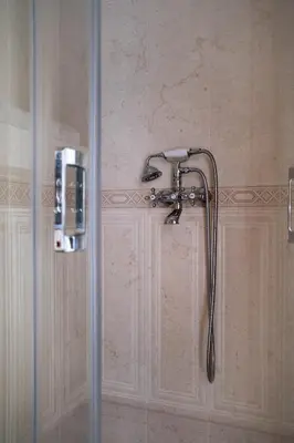 a shower with a shower head in a bathroom at 5 Villa Vitosha Classic Stays in Hisarya