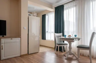 a kitchen with a table and chairs in a room at 5 Villa Vitosha Classic Stays in Hisarya