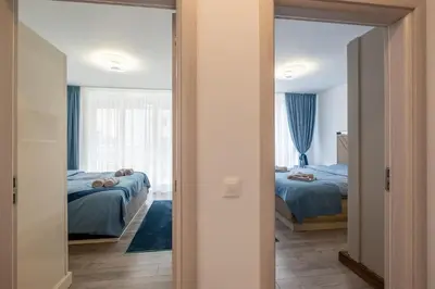 a bedroom with two beds and a mirror at Elegant Deluxe 2 Bedroom apartment in Sofia