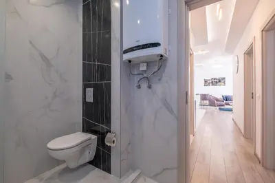 a bathroom with a toilet and a sink at Elegant Deluxe 2 Bedroom apartment in Sofia