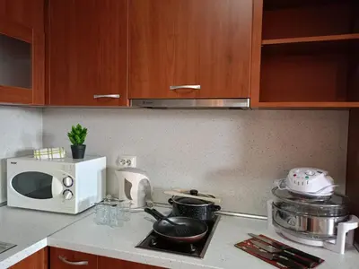 a kitchen with a white microwave and a stove top oven at Mountain Paradise 1 - 2 Bedroom - Large apartment in Bansko