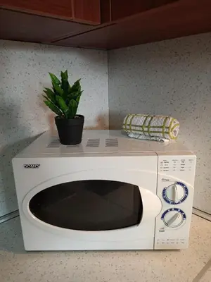a white microwave with a plant on top of it at Mountain Paradise 1 - 2 Bedroom - Large apartment in Bansko