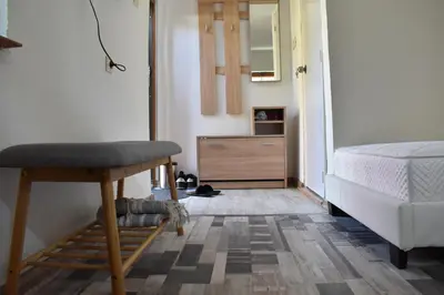 a bedroom with a bed and a chair and a dresser at Диковата къща in Lesidren