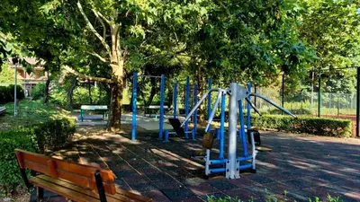 a playground in a park with a bench at Диковата къща in Lesidren