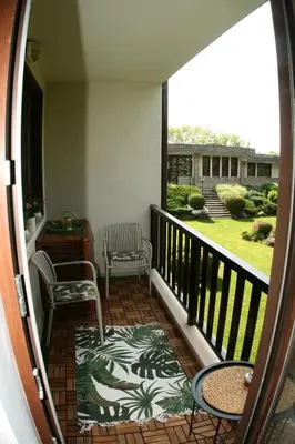 a balcony with two chairs and a table at Апартамент ДАРА in Smolyan