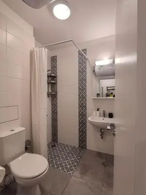 a bathroom with a toilet and a shower and a sink at Апартамент ДАРА in Smolyan