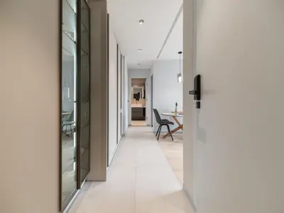 a hallway with glass doors and a dining room at APEX Apartments Sofia - MountainView in Sofia