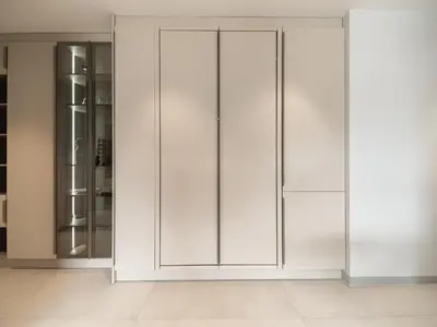 a white closet with glass doors in a room at APEX Apartments Sofia - MountainView in Sofia