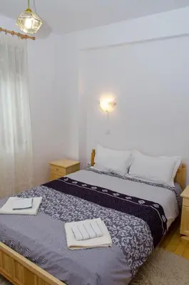 a bedroom with a bed with two towels on it at Guest House JoJi in Sapareva Banya