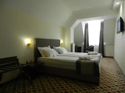a bedroom with a large bed and a window at Central Hotel Sofia in Sofia