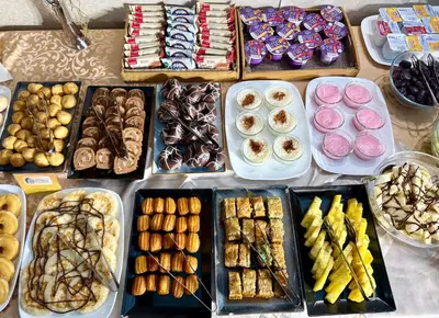 a table full of different types of desserts and pastries at Central Hotel Sofia in Sofia