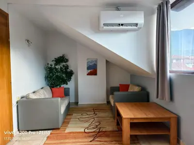 a living room with a couch and a table at Lara's cosy apartment 200 m from lift in Bansko