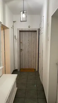 a hallway with a wooden door in a room at Кокетно Кътче in Sofia