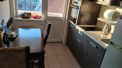 a small kitchen with a table and a sink at Studio Kalo in Sofia