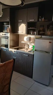 a kitchen with a white refrigerator and a sink at Studio Kalo in Sofia