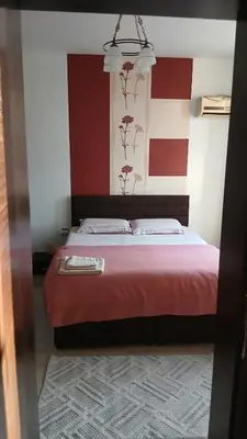 a bedroom with a bed with red and white walls at Studio Kalo in Sofia
