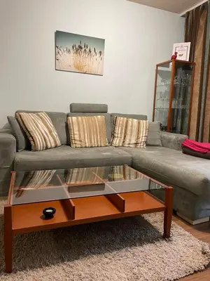 a living room with a couch and a glass coffee table at Eleonor Mountain Apartment 2 in Bansko