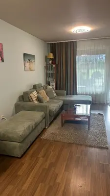 a living room with a couch and a coffee table at Eleonor Mountain Apartment 2 in Bansko