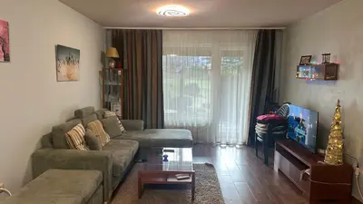 a living room with a couch and a table at Eleonor Mountain Apartment 2 in Bansko