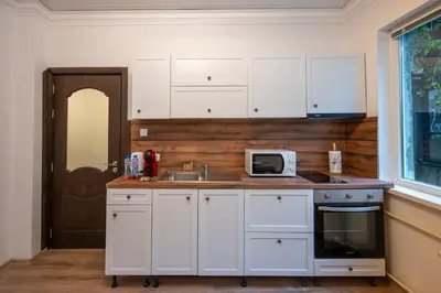a kitchen with white cabinets and a sink and a microwave at Martin's Treasure TOP CENTER in Sofia