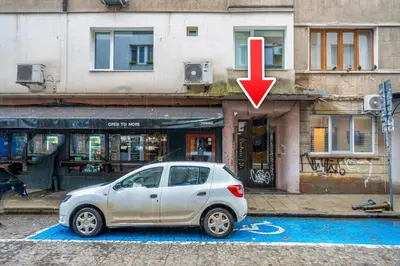a car parked in front of a building with a red arrow at Martin's Treasure TOP CENTER in Sofia