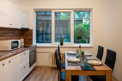 a kitchen with a table with chairs and a window at Martin's Treasure TOP CENTER in Sofia