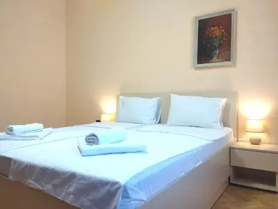 a bedroom with a white bed with towels on it at Central Vintage Apartment for 4 Guests & Private Parking in Plovdiv