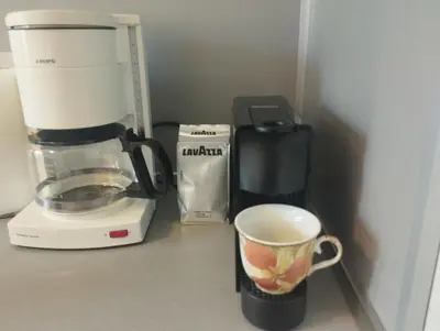 a coffee maker and a coffee cup on a counter at Central Vintage Apartment for 4 Guests & Private Parking in Plovdiv